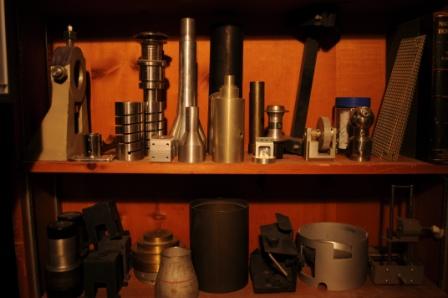 Shelves of various found objects, metal scraps, and other discarded pieces.